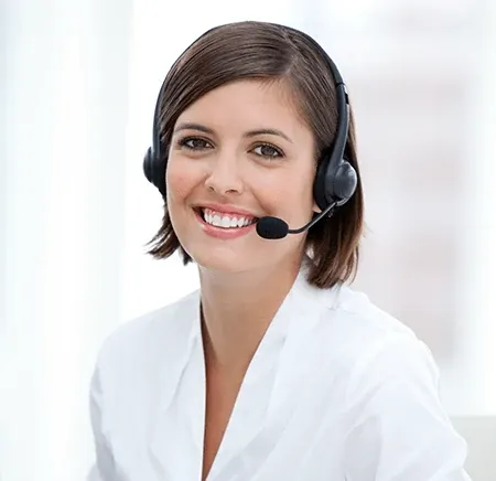 Smiling woman wearing a headset in a bright office setting, representing customer service or support roles.